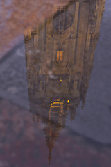 Oviedo cathedral is reflected in a puddle