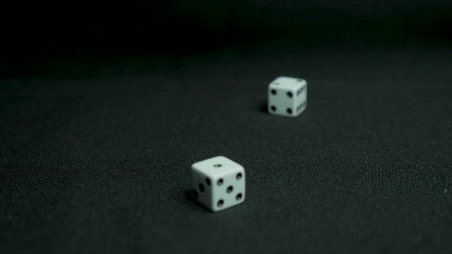 Detail of dice on black table. Dice throw on the table. Close up