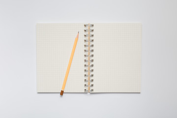 School notebook with yellow pencil