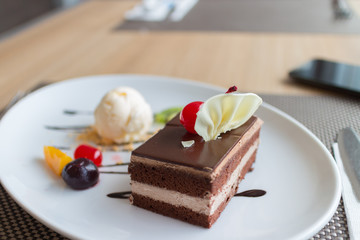 chocolate layer cake and vanilla ice cream with fresh fruit and cherry