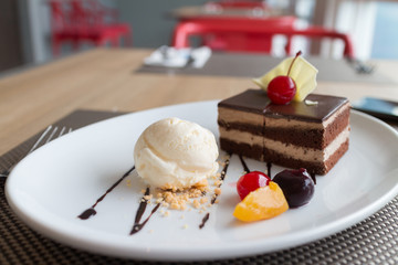 chocolate layer cake and vanilla ice cream with fresh fruit and cherry