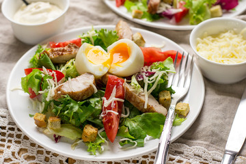 Caesar salad with lettuce, tomato, grilled chicken and cheese