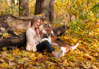 Fototapeta premium Beautiful girl with dog in the park.
