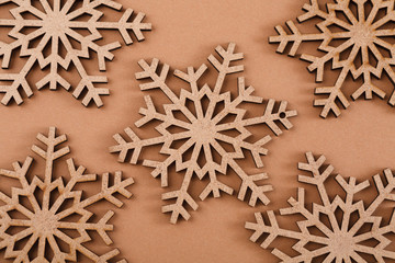 Wooden snowflakes pattern on beige background
