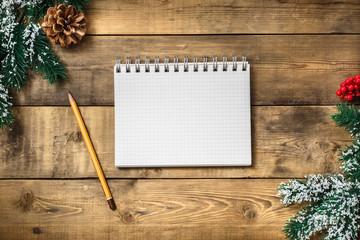 Blank paper notebook on brown wooden table background. Top view with copy space.