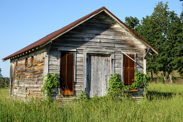 Old little wood building with rusty metal roof