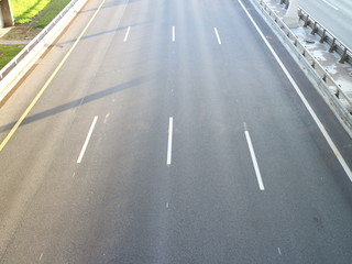 high-speed road at sunset over the sea city	