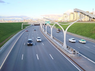 high-speed road at sunset over the sea city	