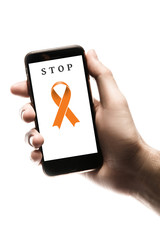 Hand holding smartphone, blank screen with orange ribbon isolated on white background. World Cancer Day. Kidney cancer concept