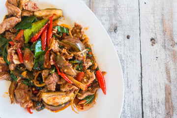 Stir Fried Wild Boar with Red Curry, thai food concept, on wooden table background.