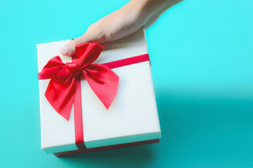 White gift box with red ribbon bow