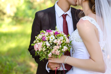 The bride and groom holding wedding bouquet