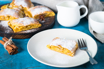 Apple strudel pie. Puff pastry on blue.