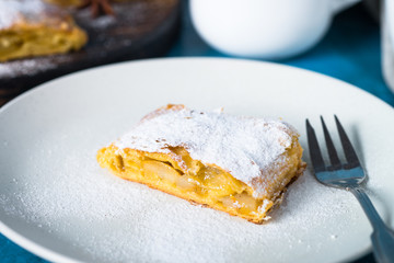 Apple strudel pie. Puff pastry on blue.
