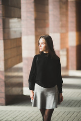 Fototapeta premium Portrait of a young beautiful woman in a urban background