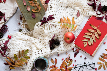 Mug of black coffee wrapped in warm scarf on wooden board. Top view, vintage style, Still life.