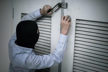 Naklejka na ściany i meble robber in black mask. robbery and crime concept.