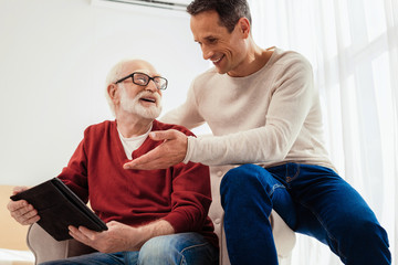 Fototapeta premium Low angle photo of two males that enjoying free time