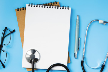 Stethoscope on a blue table, concept of medicine