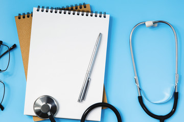 Stethoscope on a blue table, concept of medicine