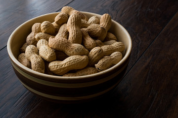 Bowl of Dry Salted Roasted Peanuts in Shell.