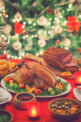 Fototapeta na wymiar Stuffed Christmas turkey dinner served in front of a Christmas tree 