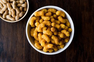 Peanut Chips on dark wooden surface.