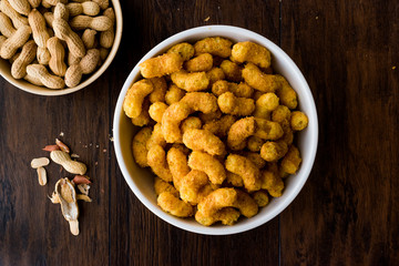 Peanut Chips on dark wooden surface.