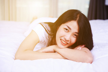 portrait beautiful woman on bed in bedroom