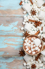 Hot Chocolate, White Marshmallows and Winter Spices on Blue Wooden Background Copy Space Flat Lay Top View Vertical