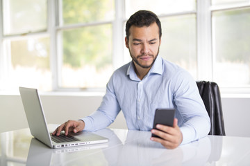 Fototapeta premium mexican attractive businessman on his 30s working at modern home office with computer laptop
