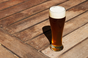 A craft beer (IPA) on a wooden table top. 