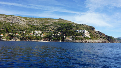 Naklejka premium wild coast of croatian town dubrovnik from a boat