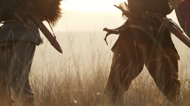 Two medieval warriors Viking are fighting with swords and shields. Contre-jour