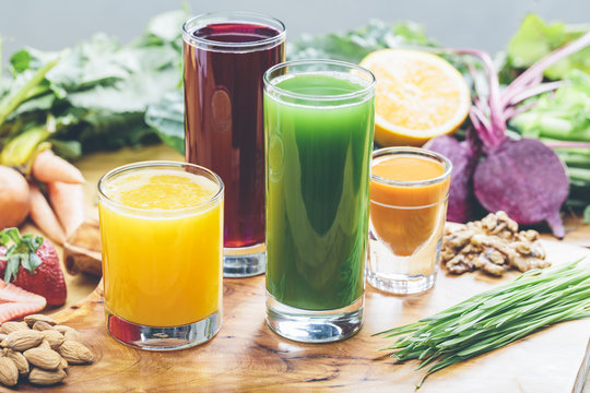 Colorful juices with an assortment of raw ingredients