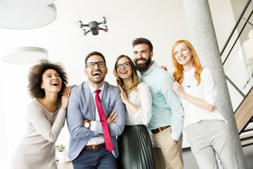 Young business people  letting the drone camera to fly over the office