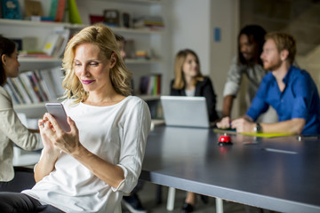 Businesswoman using mobile phone in office