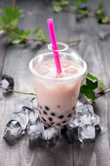 Red bubble tea and black tapioca pearls on crushed ice