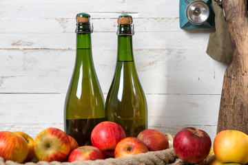 organic fresh apples with bottle of Normandy cider