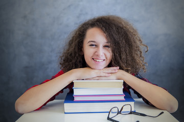 Curly hair teen girl rest from learning on books