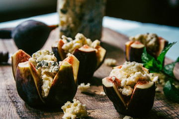 Fresh Figs With Blue Cheese on a Wooden Cutting Board