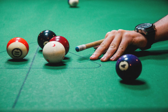 Young man playing billiards