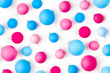 Christmas composition. Pattern made of  blue and pink Christmas balls on wite background. Flat lay, top view