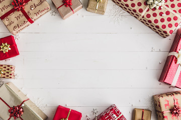 Wrapped Christmas presents on a white wooden background