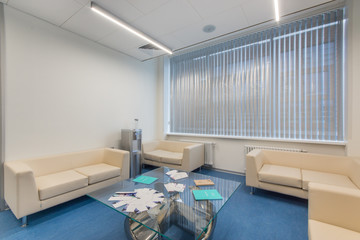 Clinic waiting area with seats and cooler