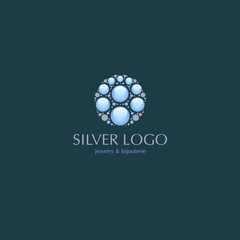 Jewelry logo. Beautiful logo on jewelry theme, shiny smooth stones, isolated on a dark blue background.
