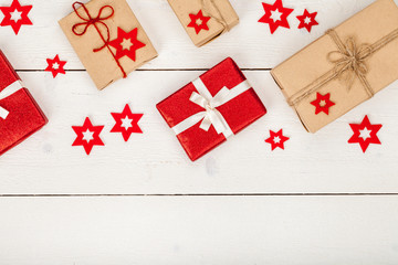 frame made of homemade wrapped christmas and new year present boxes and decoration on wooden background with copy space for text. holiday and celebration concept. above view, flat lay.