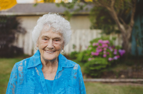 Happy portrait of old - elderly - woman in backyard