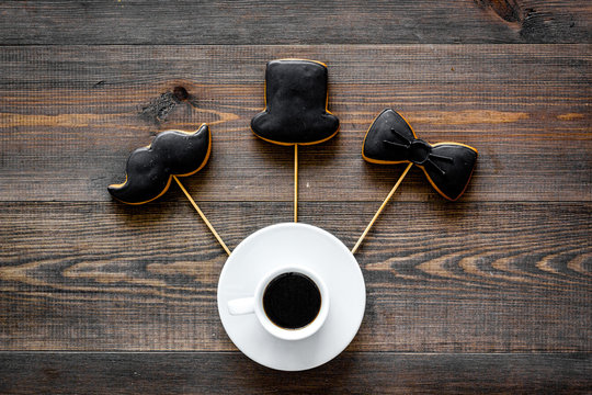 Black tie, mustache and hat cookies on sticks for happy father's day present cookies wooden background top view space for text