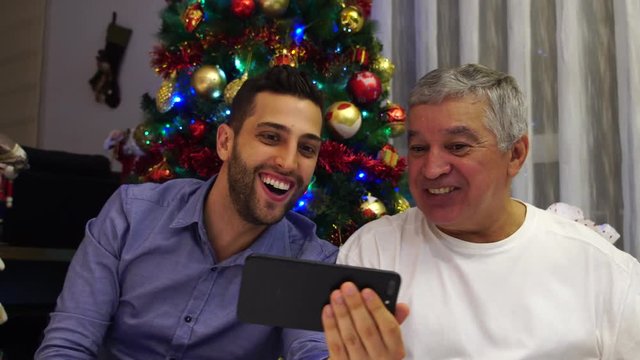 Father and Son Having a Video Chat on Christmas Day